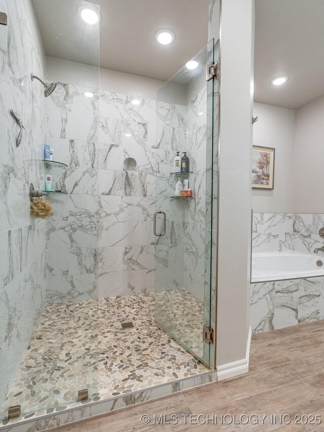 12349 County Road 3571, Ada, OK 74820 - full bath with a marble finish shower, a garden tub, recessed lighting, and wood finished floors