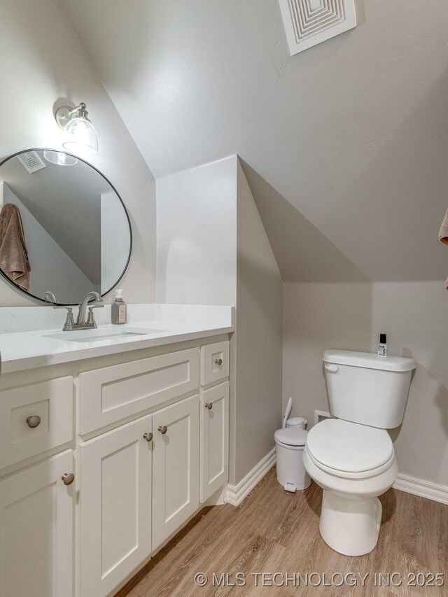 12349 County Road 3571, Ada, OK 74820 - half bathroom with wood finished floors, vanity, and vaulted ceiling