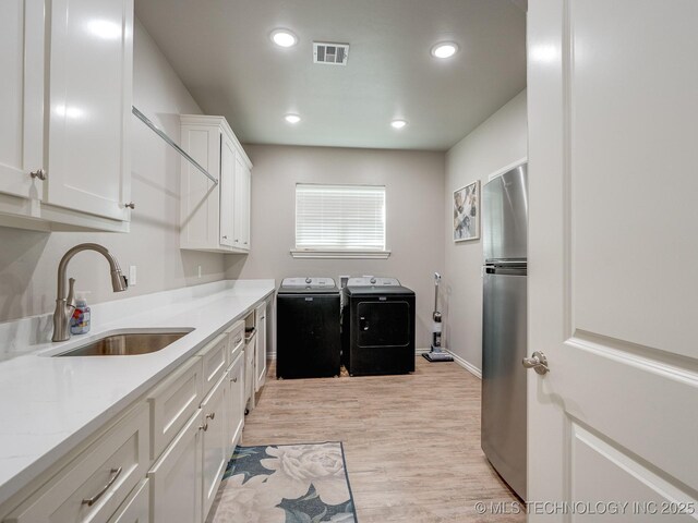 12349 County Road 3571, Ada, OK 74820 - laundry area featuring washer and dryer, light wood-type flooring, and recessed lighting