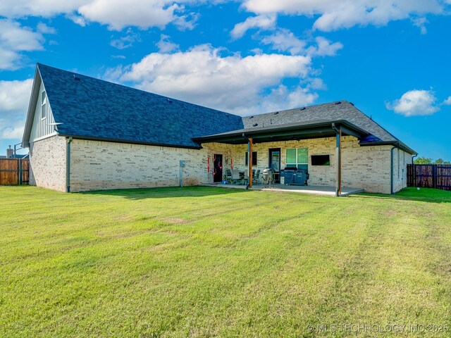 12349 County Road 3571, Ada, OK 74820 - rear view of house with brick siding, a patio, and roof with shingles