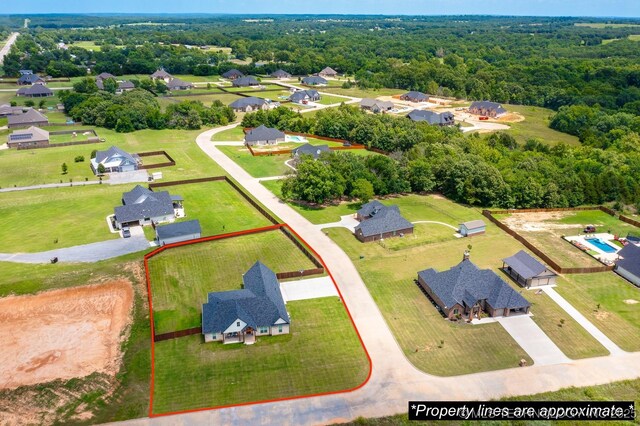 12349 County Road 3571, Ada, OK 74820 - aerial view of residential area featuring property boundaries highlighted and a heavily wooded area