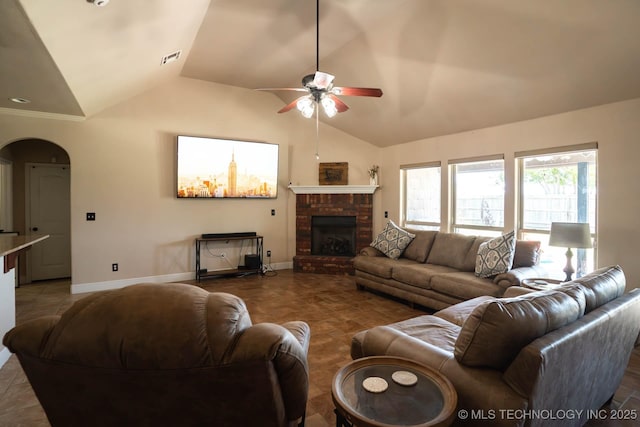 12901 N 124th E Pl, Collinsville, OK 74021 - living room with lofted ceiling, a ceiling fan, arched walkways, and a fireplace