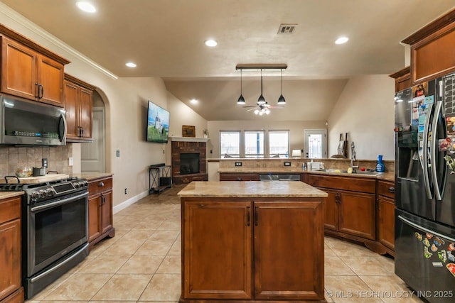 12901 N 124th E Pl, Collinsville, OK 74021 - kitchen with appliances with stainless steel finishes, a ceiling fan, lofted ceiling, light tile patterned floors, and tasteful backsplash