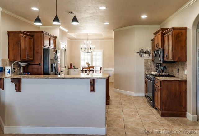 12901 N 124th E Pl, Collinsville, OK 74021 - kitchen featuring stainless steel appliances, light stone countertops, a chandelier, crown molding, and recessed lighting