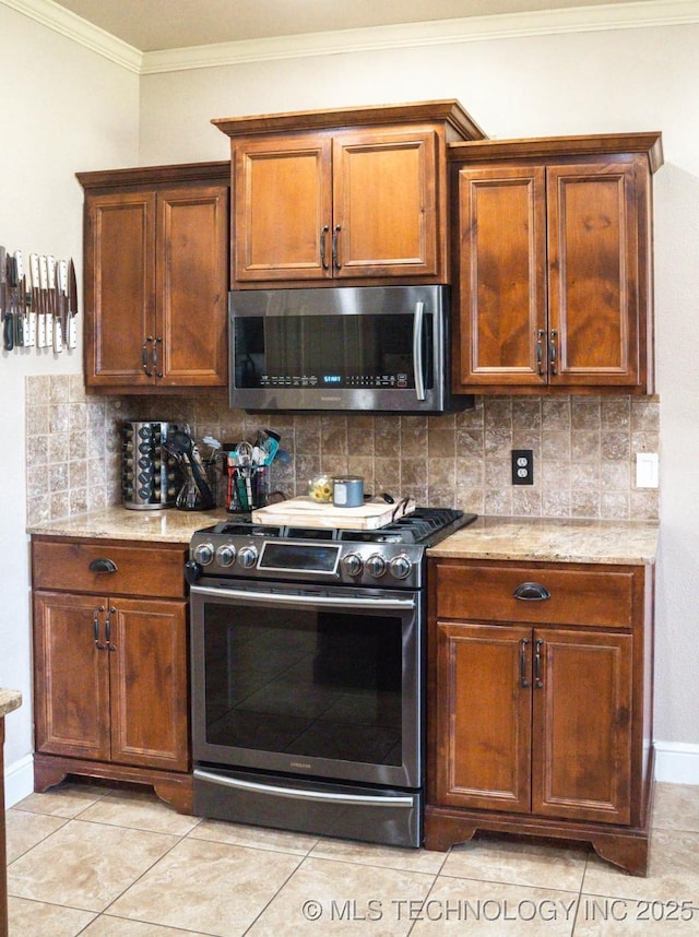 12901 N 124th E Pl, Collinsville, OK 74021 - kitchen featuring appliances with stainless steel finishes, crown molding, decorative backsplash, light stone countertops, and light tile patterned flooring