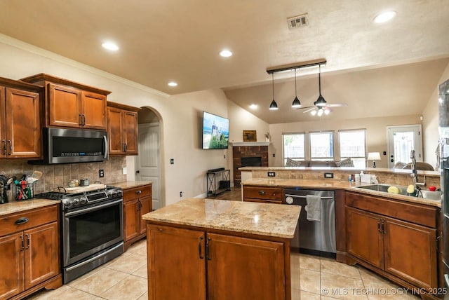 12901 N 124th E Pl, Collinsville, OK 74021 - kitchen featuring appliances with stainless steel finishes, a ceiling fan, vaulted ceiling, open floor plan, and tasteful backsplash