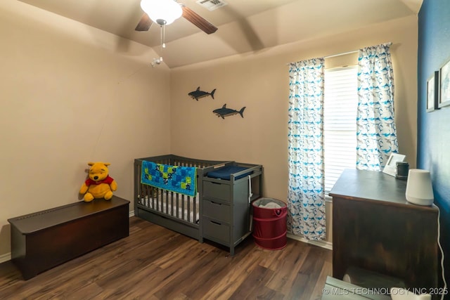 12901 N 124th E Pl, Collinsville, OK 74021 - bedroom featuring dark wood-style flooring, a crib, a ceiling fan, and vaulted ceiling