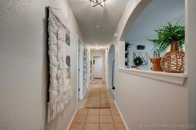 11001 N 146th E Ave, Owasso, OK 74055 - hallway featuring arched walkways and light tile patterned flooring