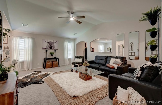 11001 N 146th E Ave, Owasso, OK 74055 - carpeted living room featuring ceiling fan, healthy amount of natural light, arched walkways, and vaulted ceiling