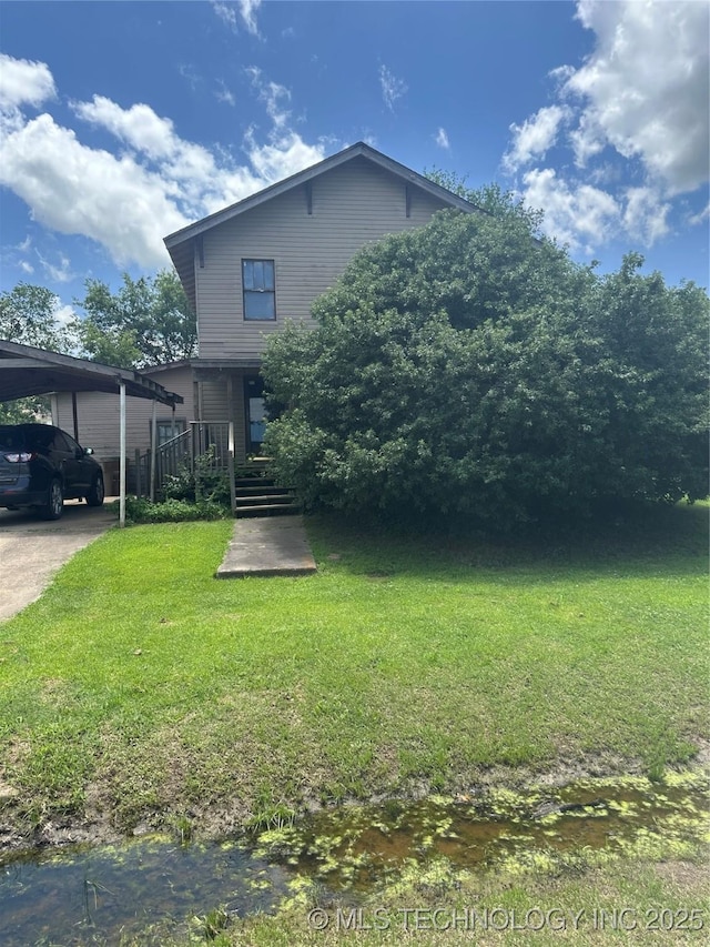 512 W Franklin, Haskell, OK 74436 - view of front facade with a front lawn, a carport, and driveway
