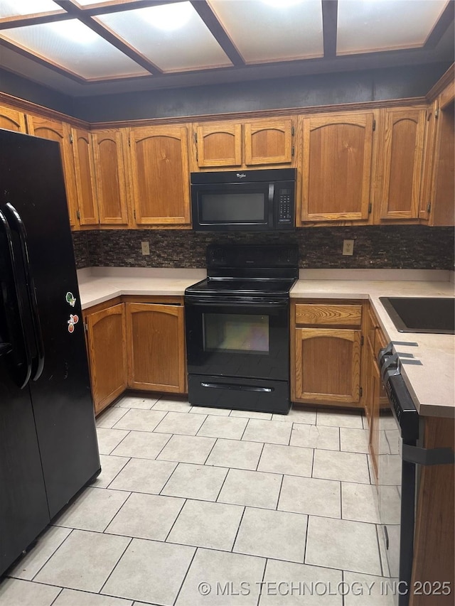 512 W Franklin, Haskell, OK 74436 - kitchen with black appliances, brown cabinets, light countertops, and backsplash