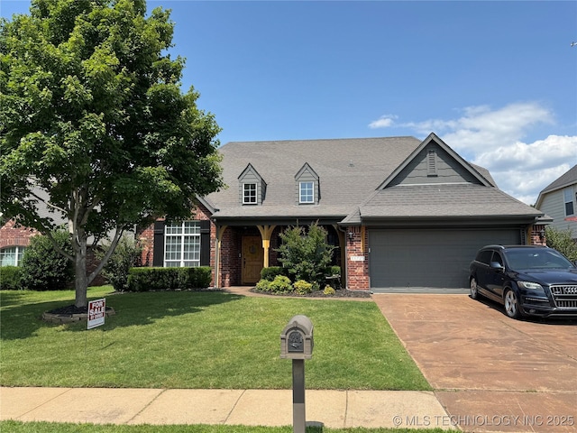 11725 S Vine Pl S, Jenks, OK 74037 - new england style home featuring a garage, brick siding, a front lawn, and driveway