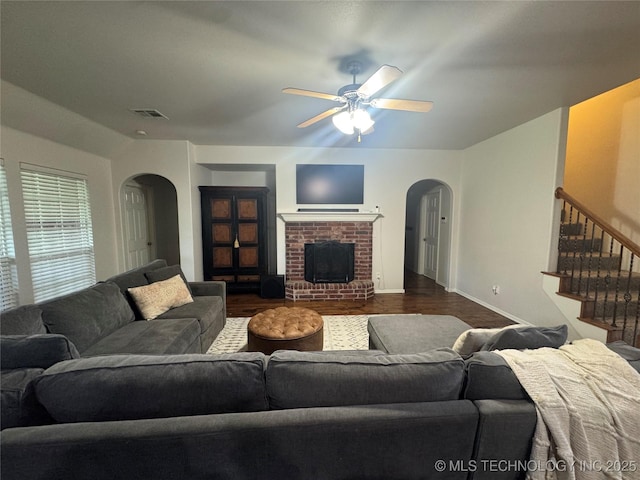 11725 S Vine Pl S, Jenks, OK 74037 - living area with arched walkways, ceiling fan, stairs, and a fireplace