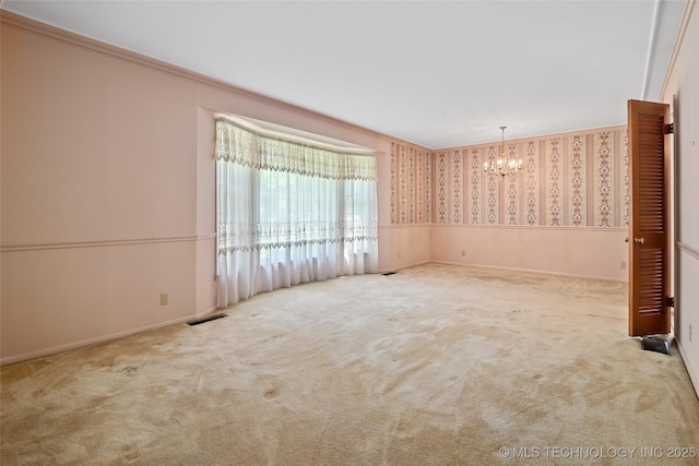 5153 S Marion Ave, Tulsa, OK 74135 - carpeted spare room with a chandelier, wallpapered walls, ornamental molding, and wainscoting