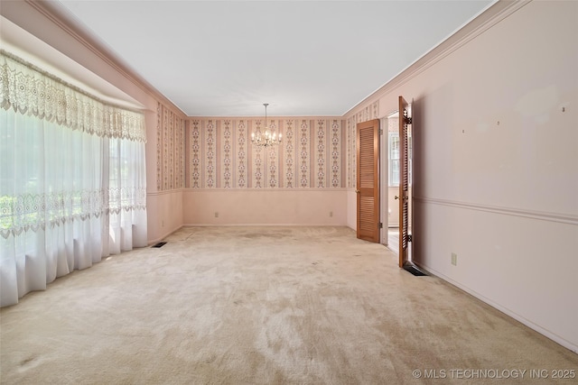 5153 S Marion Ave, Tulsa, OK 74135 - carpeted spare room with a chandelier, wallpapered walls, crown molding, and wainscoting