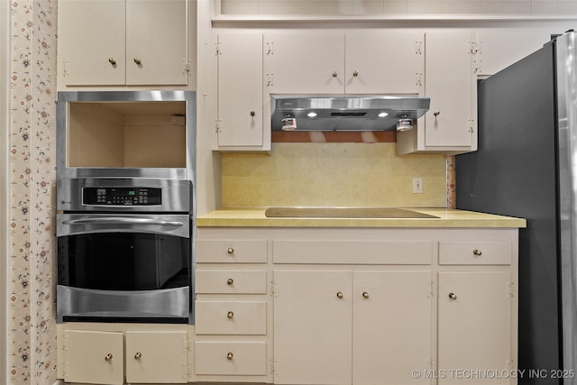 5153 S Marion Ave, Tulsa, OK 74135 - kitchen with stainless steel appliances, ventilation hood, light countertops, and backsplash