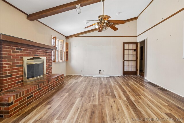 5153 S Marion Ave, Tulsa, OK 74135 - unfurnished living room featuring ceiling fan, a fireplace, light wood finished floors, crown molding, and beamed ceiling