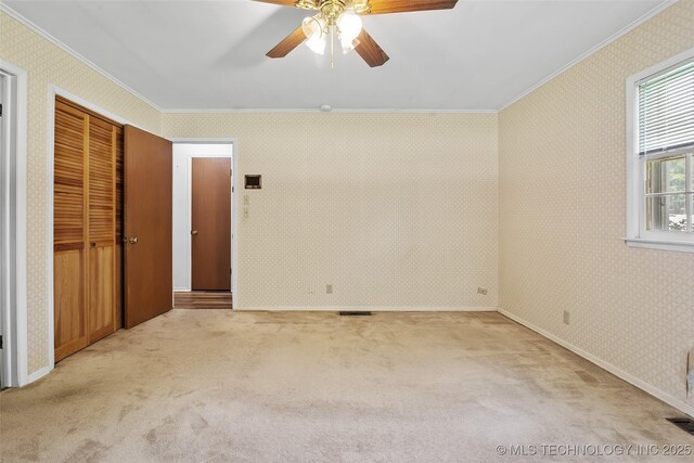 5153 S Marion Ave, Tulsa, OK 74135 - unfurnished bedroom with ornamental molding, wallpapered walls, carpet, and ceiling fan