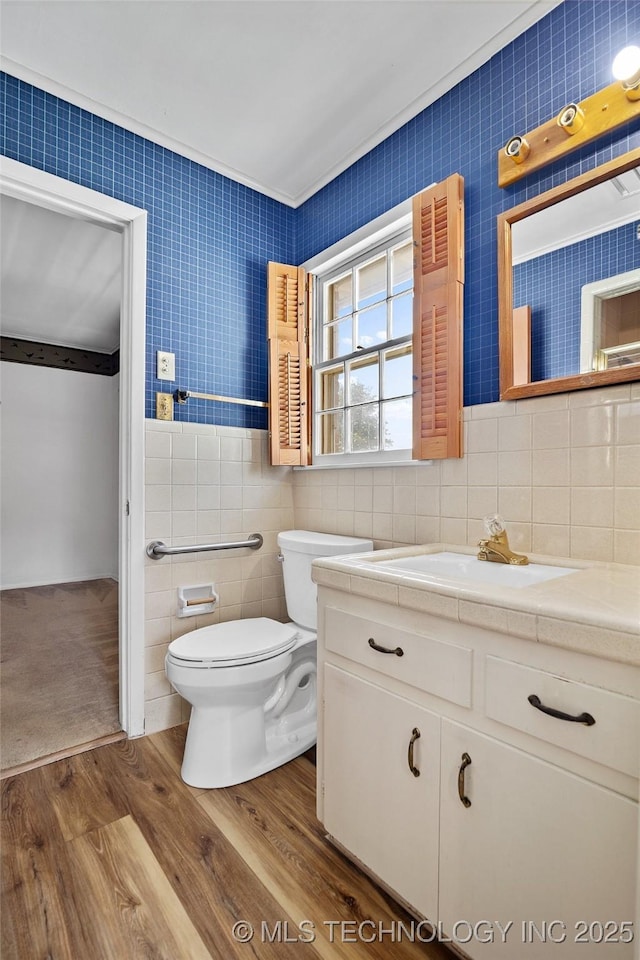 5153 S Marion Ave, Tulsa, OK 74135 - bathroom featuring wood finished floors, vanity, and tile walls