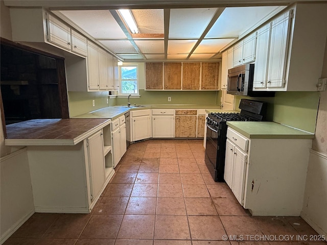 3024 S Ash Ct, Broken Arrow, OK 74012 - kitchen with appliances with stainless steel finishes, tile counters, light tile patterned floors, and white cabinets