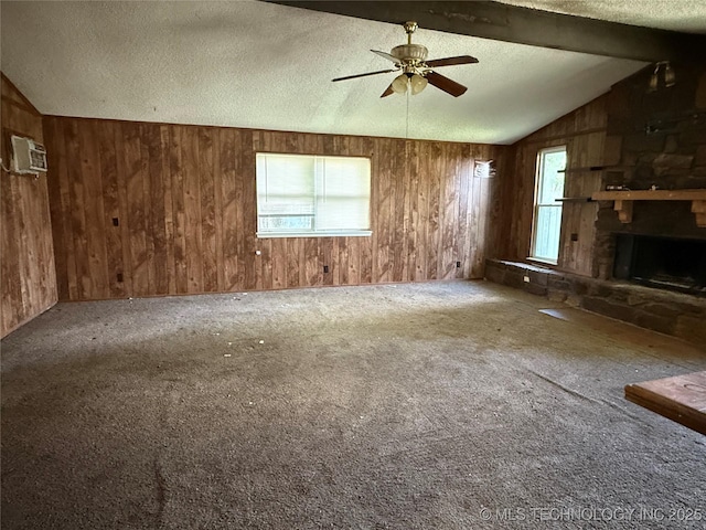 3024 S Ash Ct, Broken Arrow, OK 74012 - unfurnished living room featuring wooden walls, ceiling fan, carpet flooring, a textured ceiling, and a fireplace