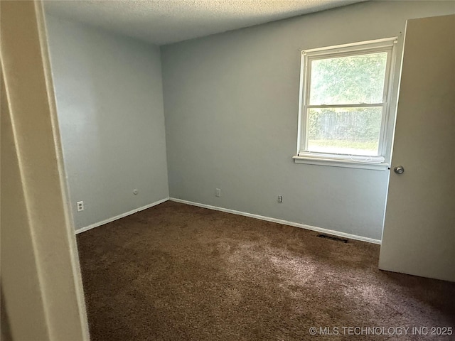 3024 S Ash Ct, Broken Arrow, OK 74012 - empty room featuring dark carpet and a textured ceiling