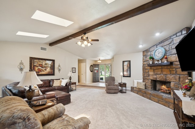 2807 W Atlanta Pl, Broken Arrow, OK 74012 - carpeted living area with a skylight, a stone fireplace, and a ceiling fan