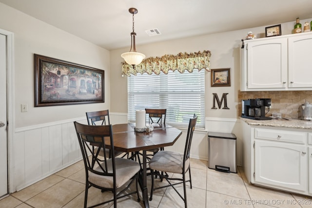 2807 W Atlanta Pl, Broken Arrow, OK 74012 - dining room featuring light tile patterned floors and a wainscoted wall