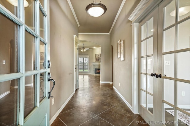 1854 E 137th Pl, Glenpool, OK 74033 - entryway with french doors, crown molding, a lit fireplace, ceiling fan, and dark tile patterned flooring