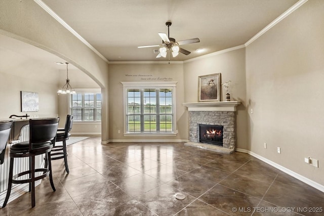 1854 E 137th Pl, Glenpool, OK 74033 - tiled living area featuring a ceiling fan, ornamental molding, a chandelier, arched walkways, and a fireplace