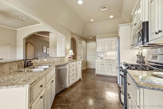 1854 E 137th Pl, Glenpool, OK 74033 - kitchen featuring stainless steel appliances, arched walkways, backsplash, light stone countertops, and recessed lighting