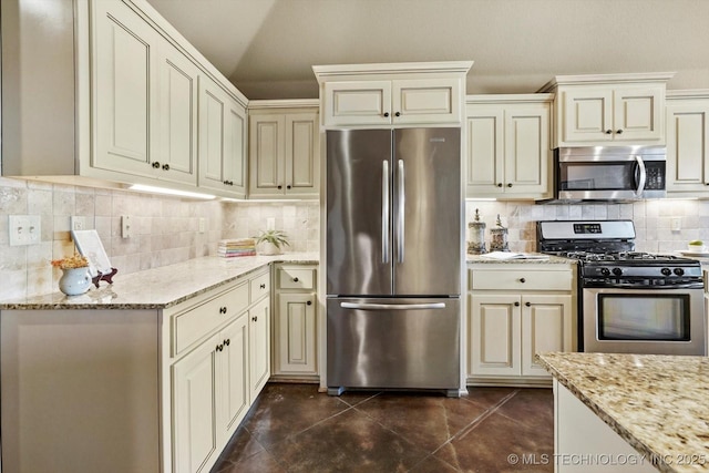 1854 E 137th Pl, Glenpool, OK 74033 - kitchen with stainless steel appliances, cream cabinets, tasteful backsplash, and light stone counters