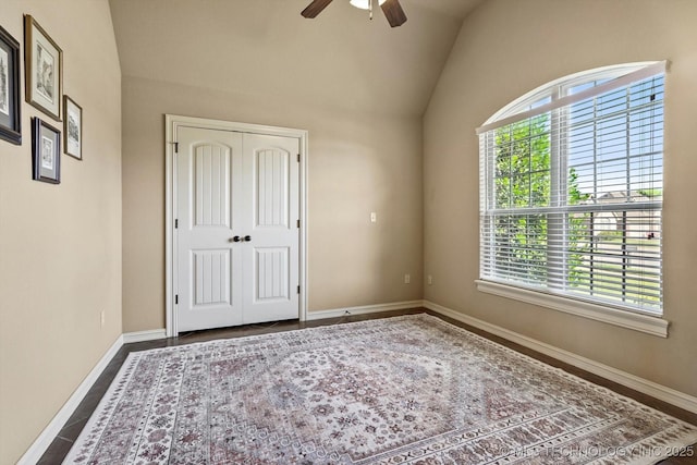 1854 E 137th Pl, Glenpool, OK 74033 - unfurnished bedroom with vaulted ceiling, multiple windows, a closet, and a ceiling fan