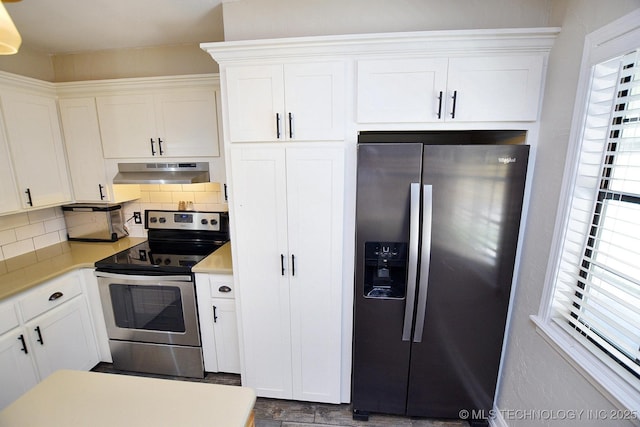 24042 S Black Valley Rd, Tahlequah, OK 74464 - kitchen featuring stainless steel appliances, under cabinet range hood, healthy amount of natural light, and backsplash