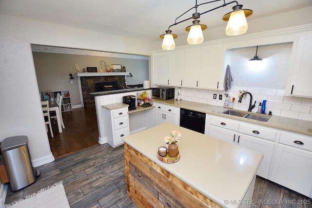 24042 S Black Valley Rd, Tahlequah, OK 74464 - kitchen with black dishwasher, stainless steel microwave, white cabinets, tasteful backsplash, and dark wood-style flooring