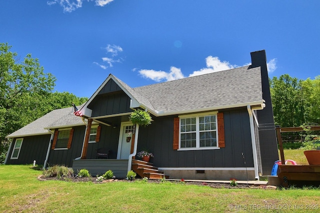 24042 S Black Valley Rd, Tahlequah, OK 74464 - view of front facade featuring a front yard, a shingled roof, a chimney, board and batten siding, and covered porch