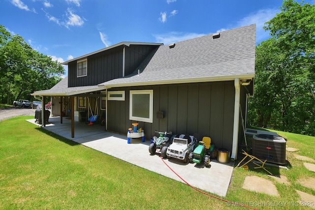 24042 S Black Valley Rd, Tahlequah, OK 74464 - back of house with board and batten siding, a yard, a patio, and roof with shingles
