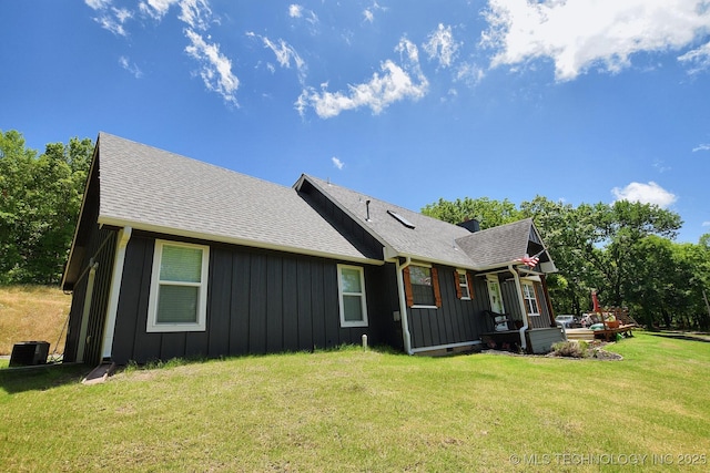 24042 S Black Valley Rd, Tahlequah, OK 74464 - rear view of property featuring board and batten siding, a lawn, and a shingled roof