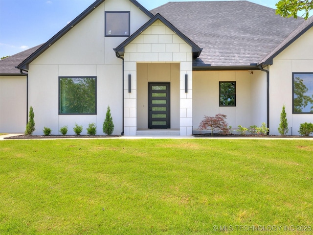 11446 Mary Knox Dr, Beggs, OK 74421 - view of front of house with roof with shingles, a front yard, and stucco siding