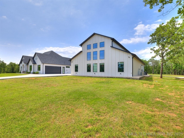 11446 Mary Knox Dr, Beggs, OK 74421 - back of house featuring board and batten siding, an attached garage, concrete driveway, and a lawn