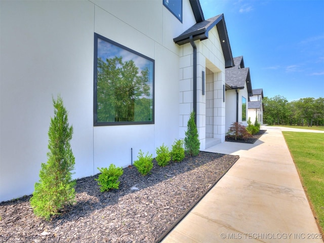 11446 Mary Knox Dr, Beggs, OK 74421 - view of home's exterior with a shingled roof and stucco siding
