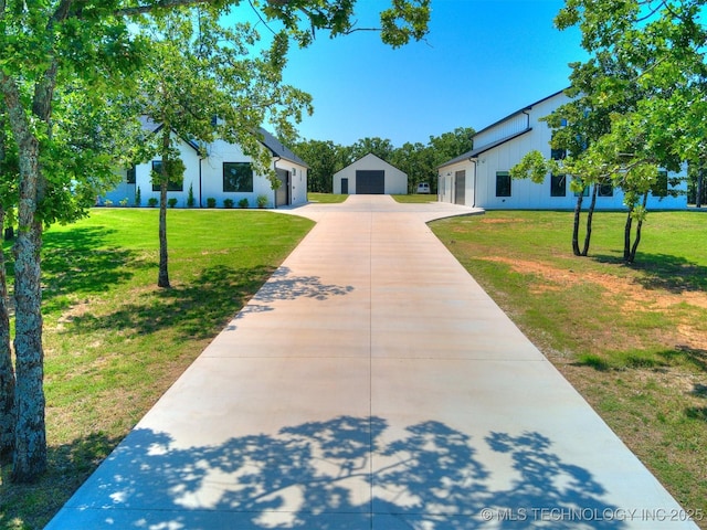 11446 Mary Knox Dr, Beggs, OK 74421 - view of front of house with a front yard, concrete driveway, and an outbuilding
