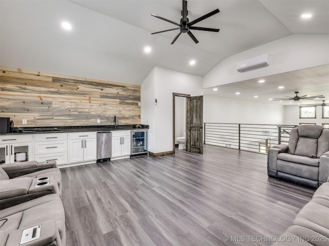 11446 Mary Knox Dr, Beggs, OK 74421 - living area with ceiling fan, a wall mounted AC, wood walls, bar with sink, and recessed lighting