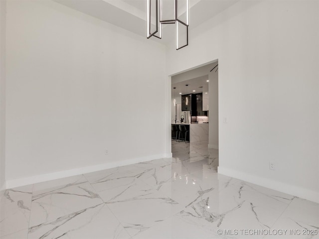 11446 Mary Knox Dr, Beggs, OK 74421 - spare room featuring light marble finish flooring and a high ceiling