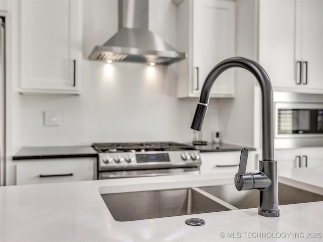 11446 Mary Knox Dr, Beggs, OK 74421 - kitchen with wall chimney range hood, stainless steel range with gas stovetop, and white cabinetry