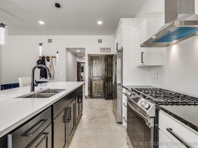 11446 Mary Knox Dr, Beggs, OK 74421 - kitchen with stainless steel appliances, wall chimney range hood, decorative light fixtures, white cabinets, and recessed lighting
