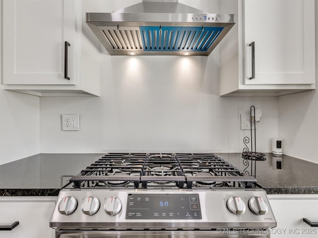 11446 Mary Knox Dr, Beggs, OK 74421 - kitchen with wall chimney exhaust hood, stainless steel gas stove, white cabinets, and dark stone countertops