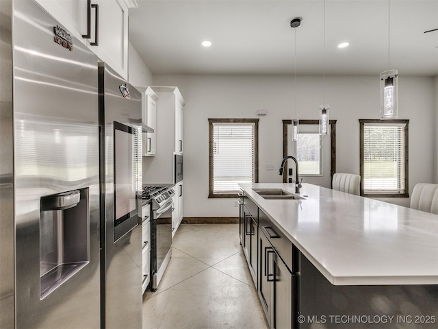 11446 Mary Knox Dr, Beggs, OK 74421 - kitchen with appliances with stainless steel finishes, a center island with sink, plenty of natural light, white cabinetry, and recessed lighting