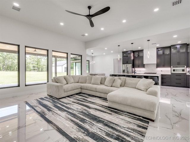 11446 Mary Knox Dr, Beggs, OK 74421 - living room featuring light marble finish floors, a ceiling fan, and recessed lighting