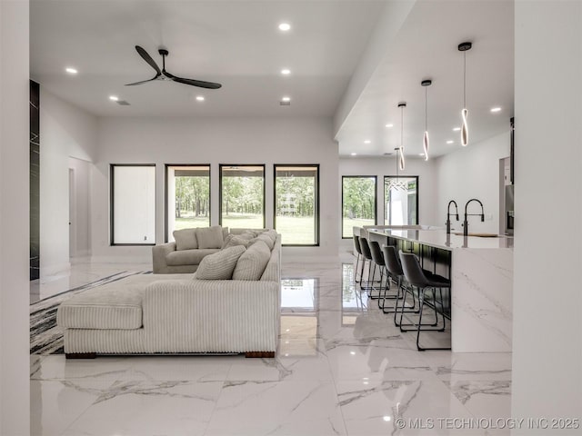 11446 Mary Knox Dr, Beggs, OK 74421 - living room featuring light marble finish floors, recessed lighting, and a ceiling fan
